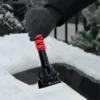 ice-scraper-removing-thick-ice-from-windshield Colorful cross-grip ice scraper removing thick ice from car windshield, fast and scratch-free